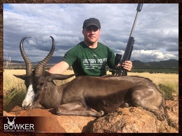 Client with a black springbok trophy shot while hunting in Africa.