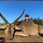 Client with a Common Reedbuck on a plains game hunt in South Africa..