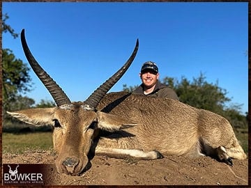 Client with a Common Reedbuck on a plains game hunt in South Africa..