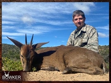 Client with a grey duiker on a plains animal safari style hunt.