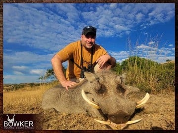 Client with a warthog a typical plains animal.